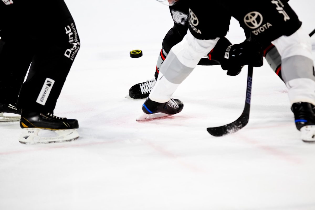 Close-up of hockey skate blades on ice — edge mechanics at ice level