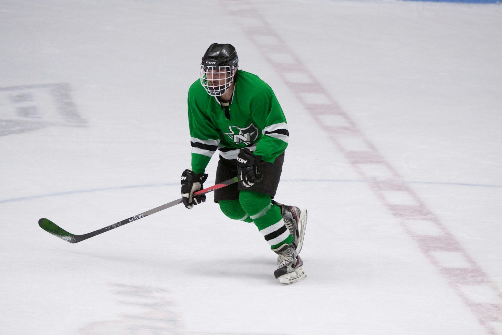 Hockey player in full equipment, on-ice training — 16-19 year old target demographic